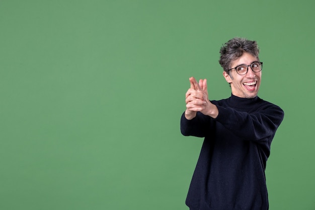 Portrait of genius man in studio shot on green wall