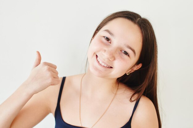 Photo portrait of a girl asian girls on white background thumb up