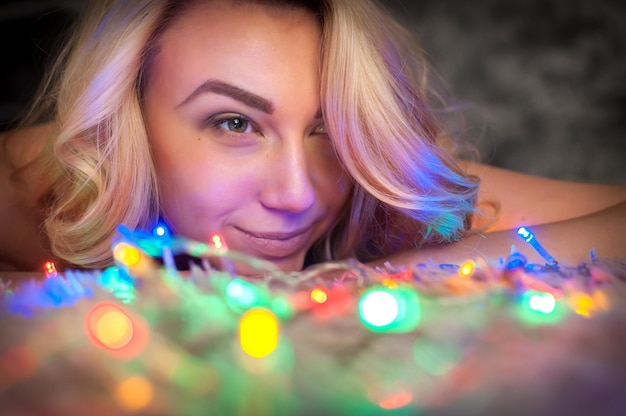 Portrait of a girl on a bed with a garland