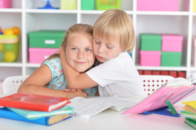 Portrait of girl and boy doing lessons