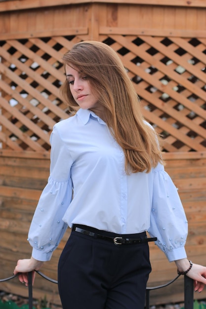 Portrait of a girl in classic clothes and long blond hair