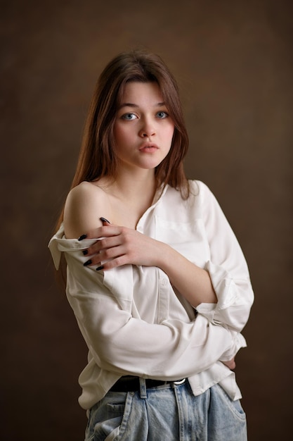 Portrait of a girl closeup a girl on a brown background a beautiful look