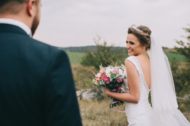 portrait of a girl and couples looking for a wedding dress