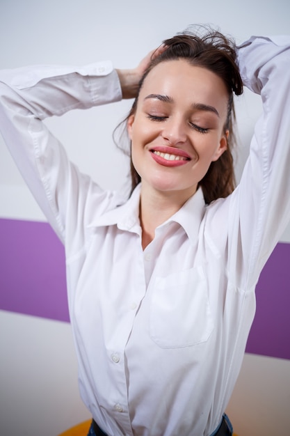 Portrait of a girl of European appearance with different emotions on her face. Attractive young brunette woman smiling