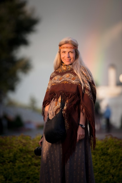 Portrait of a girl in folk costume with a rainbow in Kolomna.