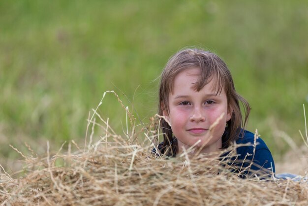 Portrait of a girl in a haystack soft focus