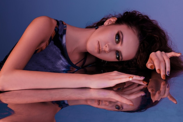 Portrait of a girl and her reflections on a neon background