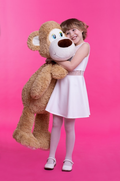 Photo portrait of a girl holding a big teddy bear