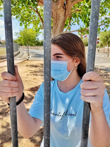 Portrait of girl holding tree trunk