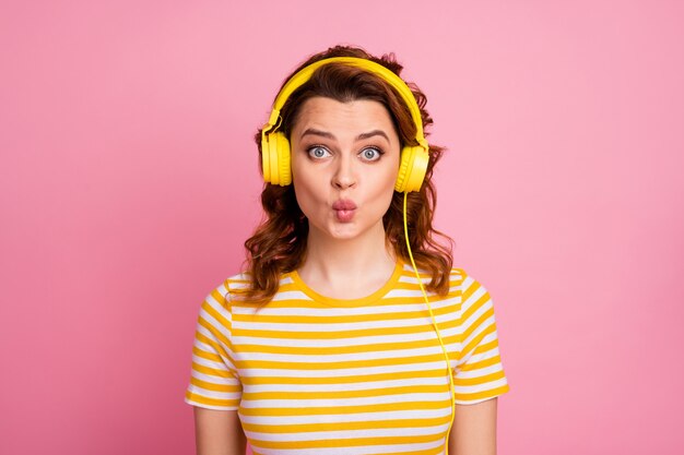 portrait of girl listening different music rock roll isolated over pink pastel color background