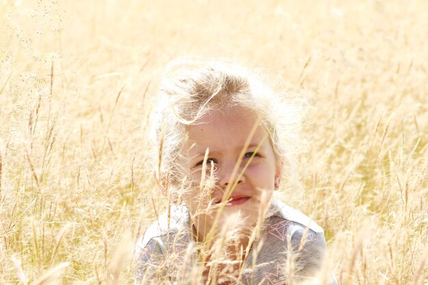 Portrait of girl looking away on field