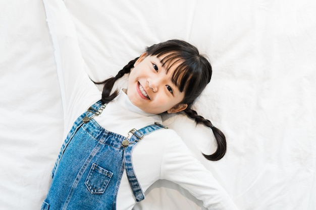 Portrait of girl lying in bed