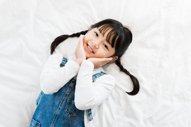 Portrait of girl lying in bed