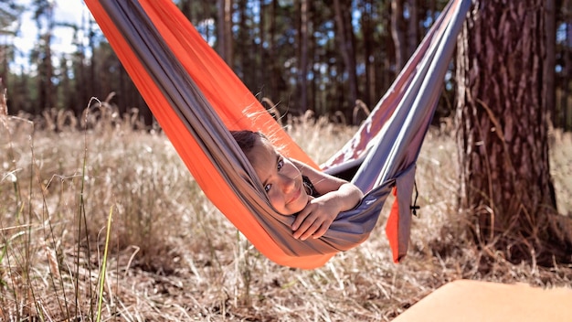 Portrait of girl lying on hammock
