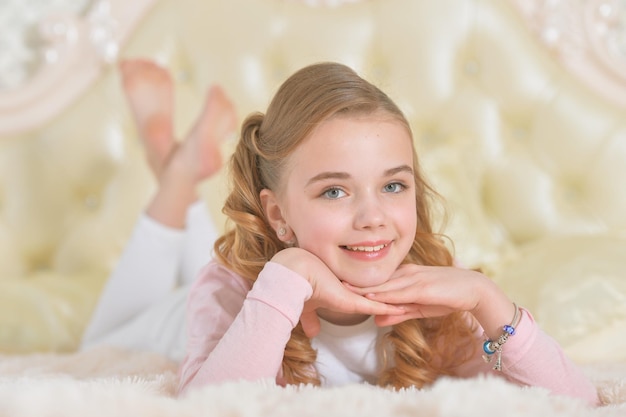 Portrait of girl lying on soft plaid