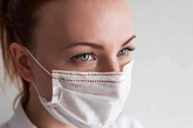 Portrait of a girl in a medical mask Close upxA