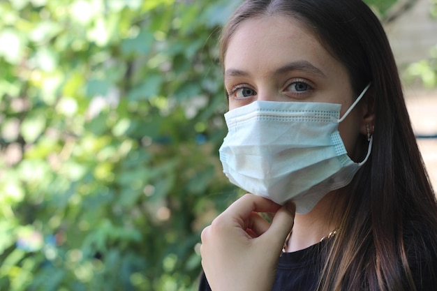 Ritratto di una ragazza con una maschera medica per strada