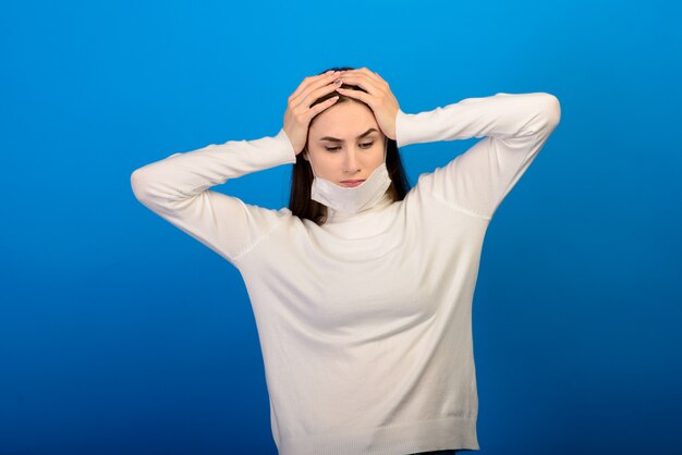 Portrait of a girl in a medical mask, which puts on a rubber glove.