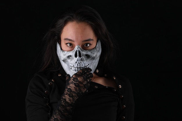 portrait of a girl in a monster mask on a black background