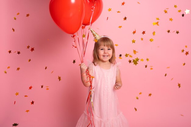 Portrait of girl playing with balloons