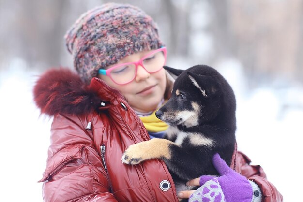 冬の女の子と子犬のポートレート