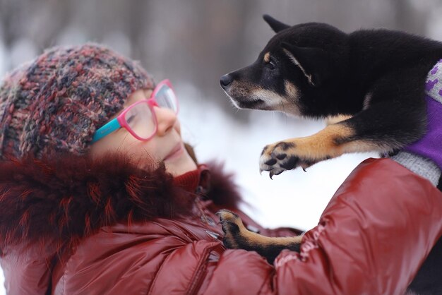 portrait of a girl and puppy winter