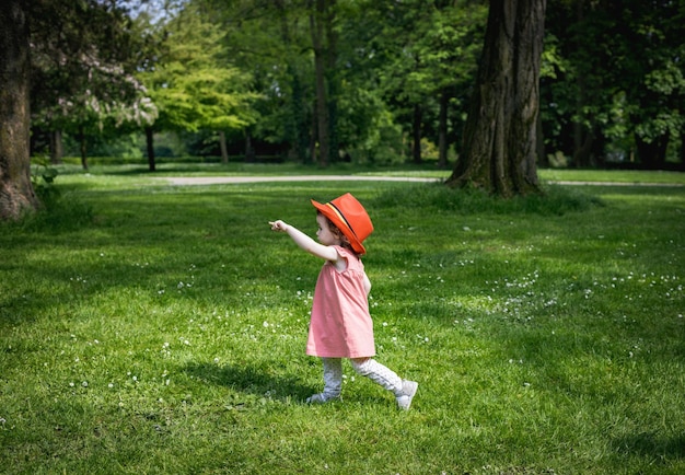 Portrait of a girl in a red belgian flag hat in the park