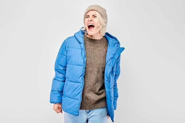 Portrait of girl screaming with anger freaking out breakdown on white background Depression uncertainty nervous stress concept