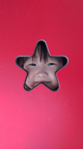 Portrait of girl seen through star shape