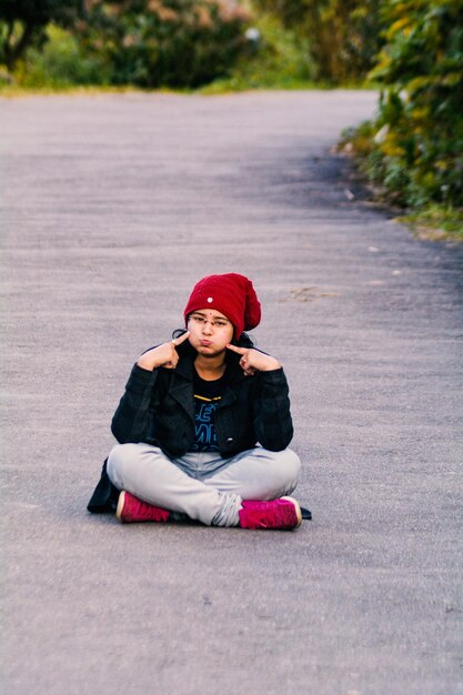 Portrait of girl sitting on road