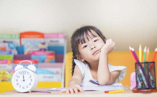 portrait of girl sitting sitting by table at home