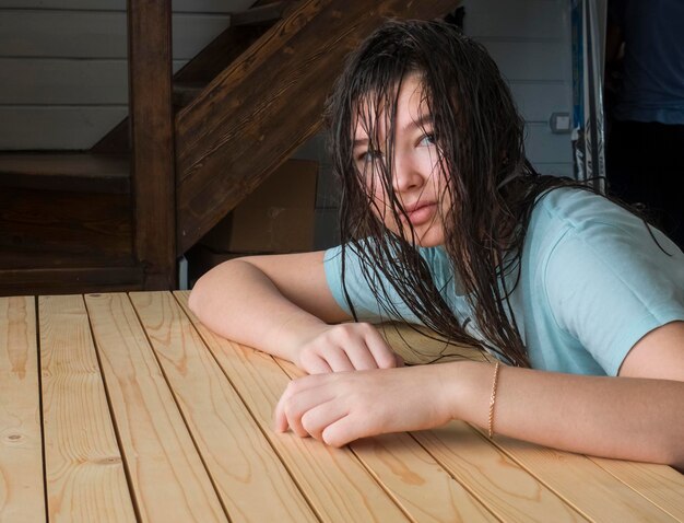 Portrait of girl sitting at wooden table