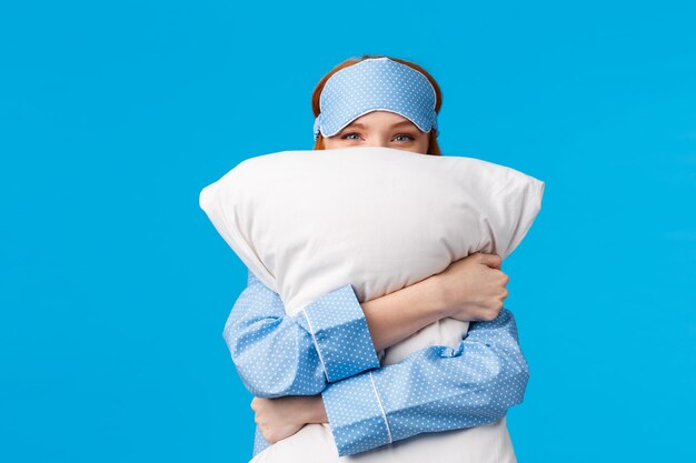 Portrait of girl standing against blue background