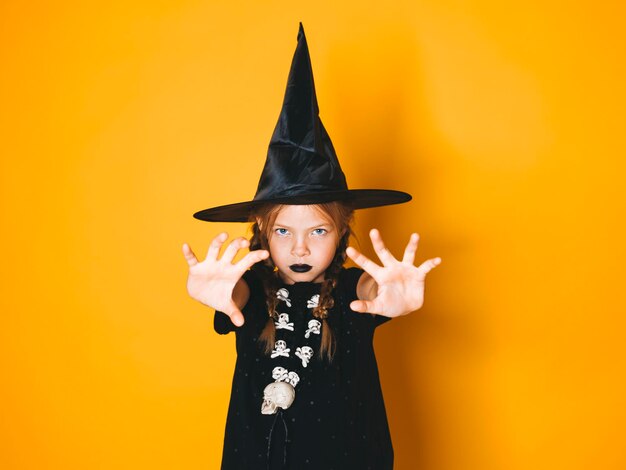 Portrait of girl standing against yellow background