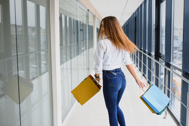 Portrait of girl standing in the mall after doing shopping