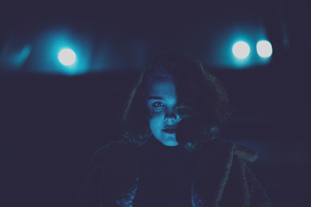 Portrait of girl standing outdoors at night