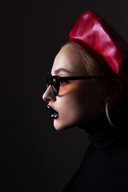 Portrait of a girl in sunglasses with black lipstick on lips