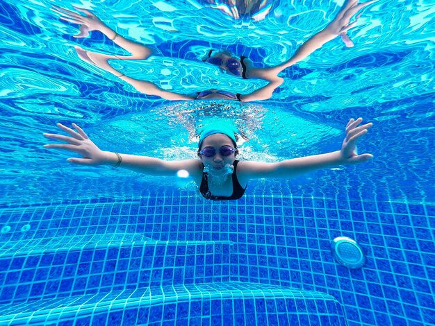 Portrait of girl swimming in pool