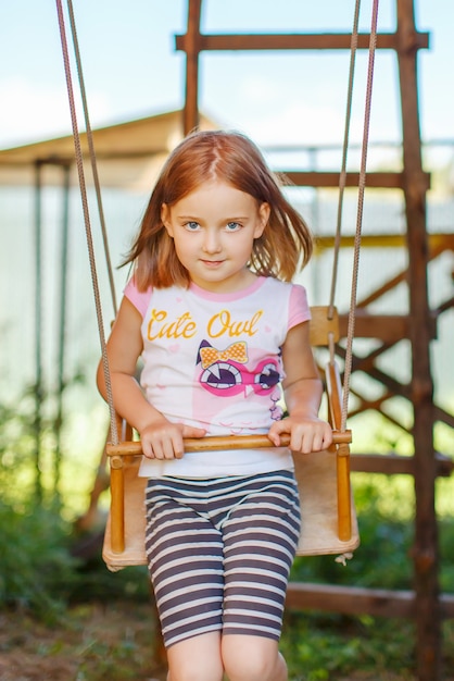 Portrait of a girl on a swing