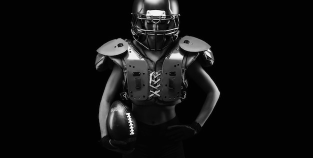 Portrait of a girl in the uniform of an American football team player. Black background. Sports concept. Mixed media