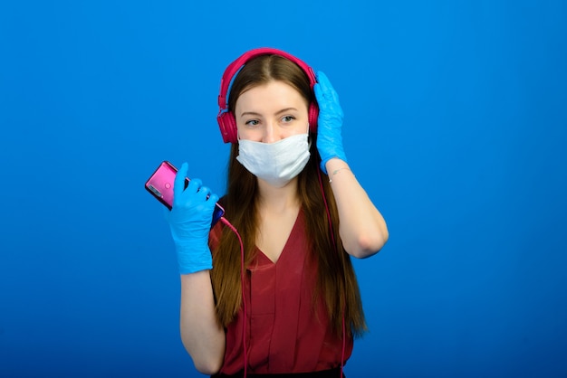 Portrait of a girl wearing a face mask on a blue background
