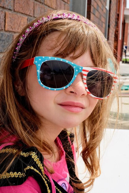 Portrait of girl wearing sunglasses outdoors