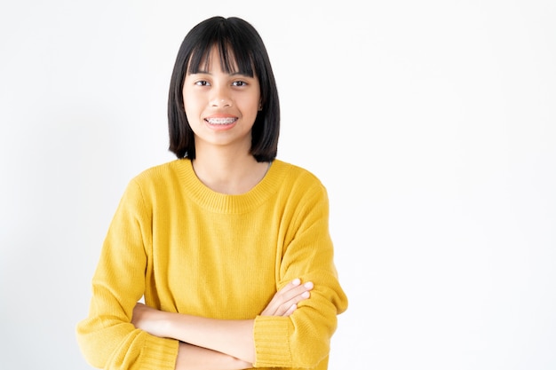 Portrait of Girl Wearing Yellow Swather with Attractive Black Eyes and Dental Brace Smiling and Happy on White 