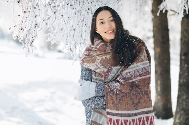 A portrait of a girl with a beautiful smile in the winter.