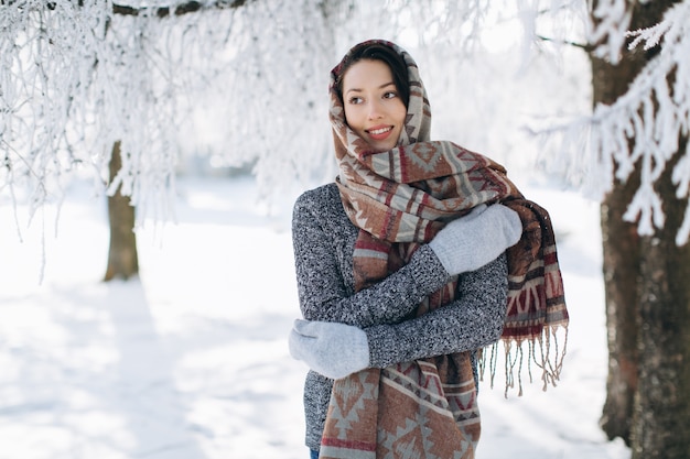 A portrait of a girl with a beautiful smile in the winter.