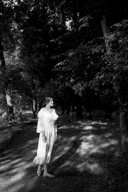 Portrait of a girl with dark hair in a forest park