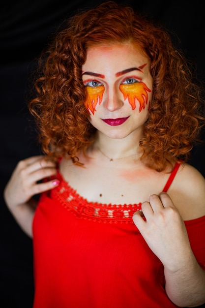 Portrait of a girl with a fiery makeup