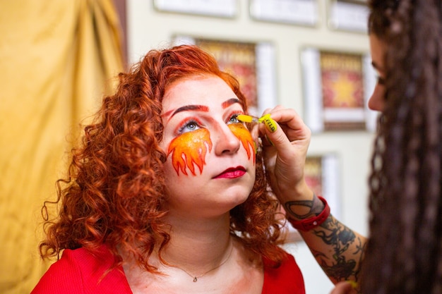 Portrait of a girl with a fiery makeup