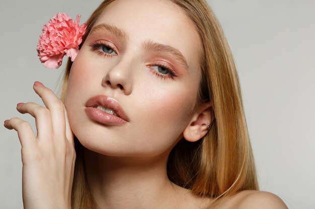 Portrait of a girl with a flower in her hair