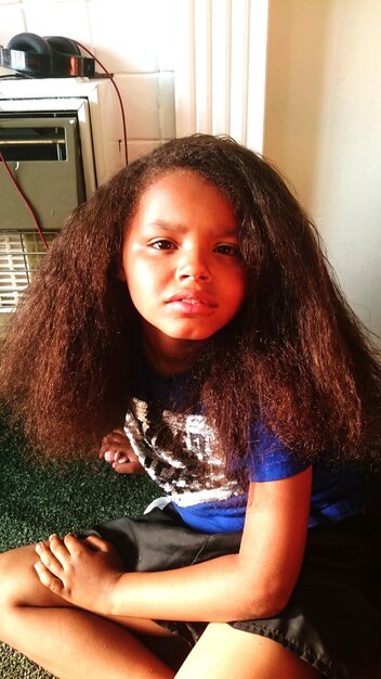 Portrait of girl with frizzy hair at home